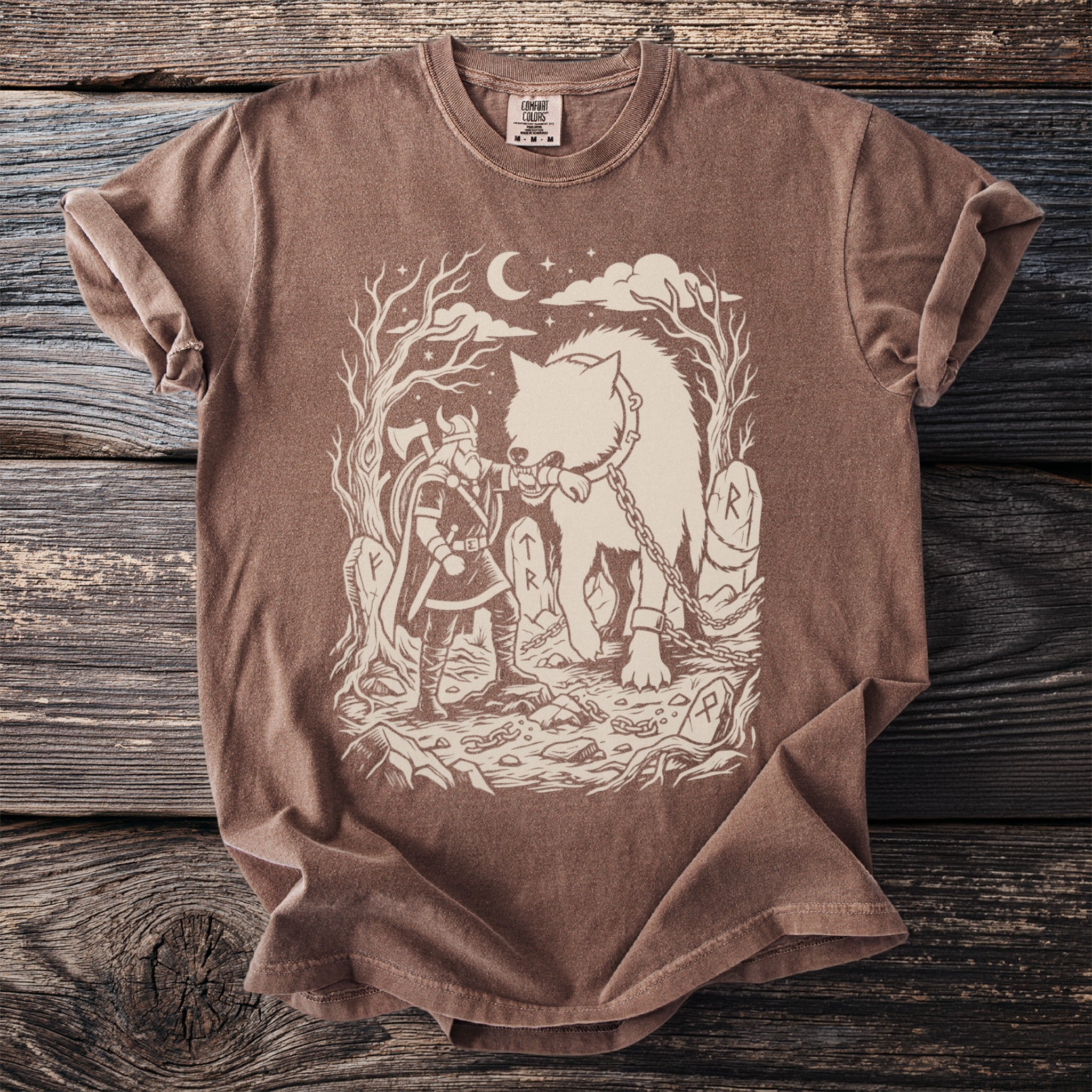 Viking warrior and chained wolf graphic on a brown t-shirt with a moon and stars.