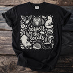 Black t-shirt with white line art of woodland animals and text "respect the locals".
