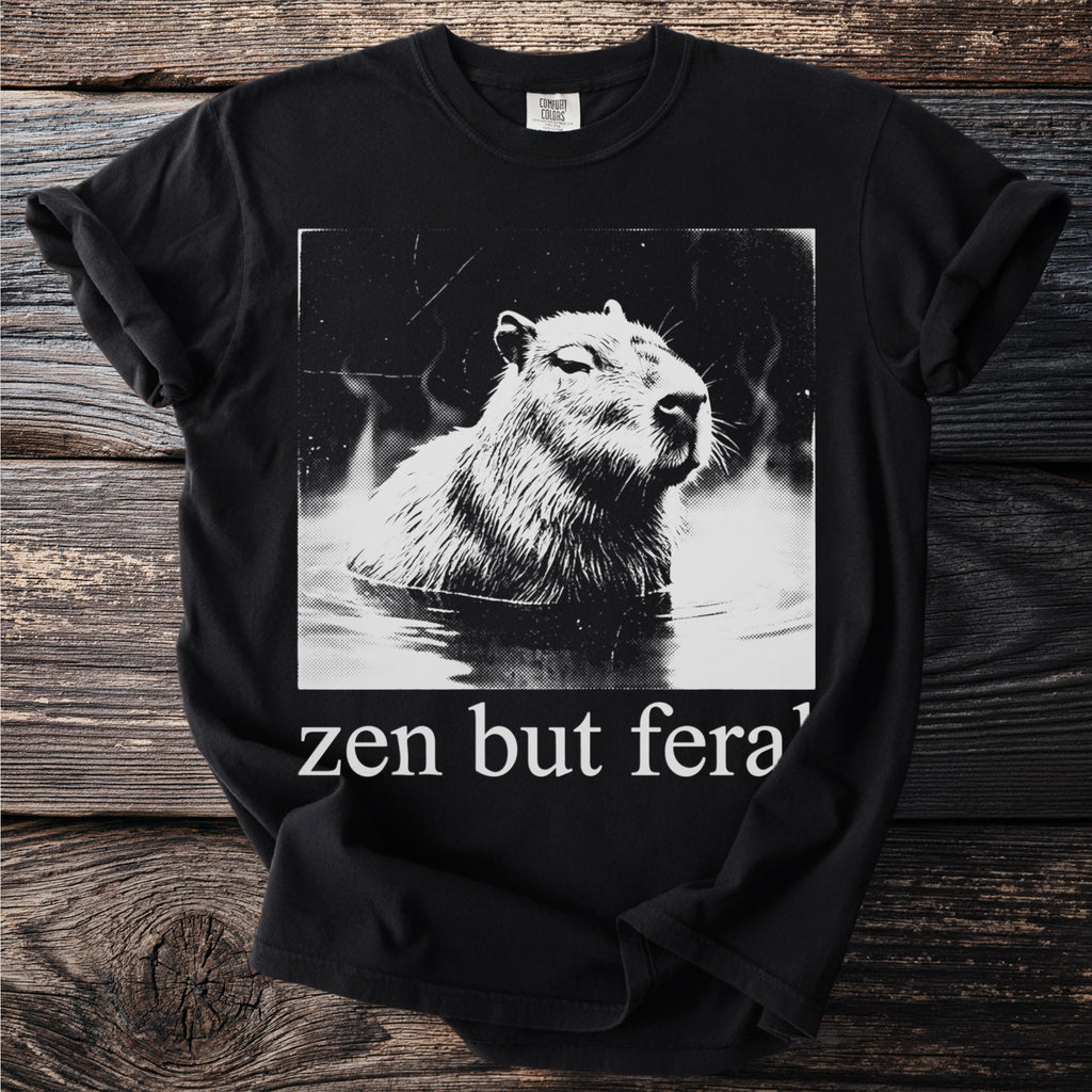 Black t-shirt with a distressed graphic of a capybara in water with text "zen but fera".