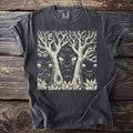 Dark gray t-shirt showing three Green Man faces emerging from trees and foliage.