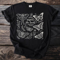 Black t-shirt with a white line drawing of moths, butterflies, and botanical elements.