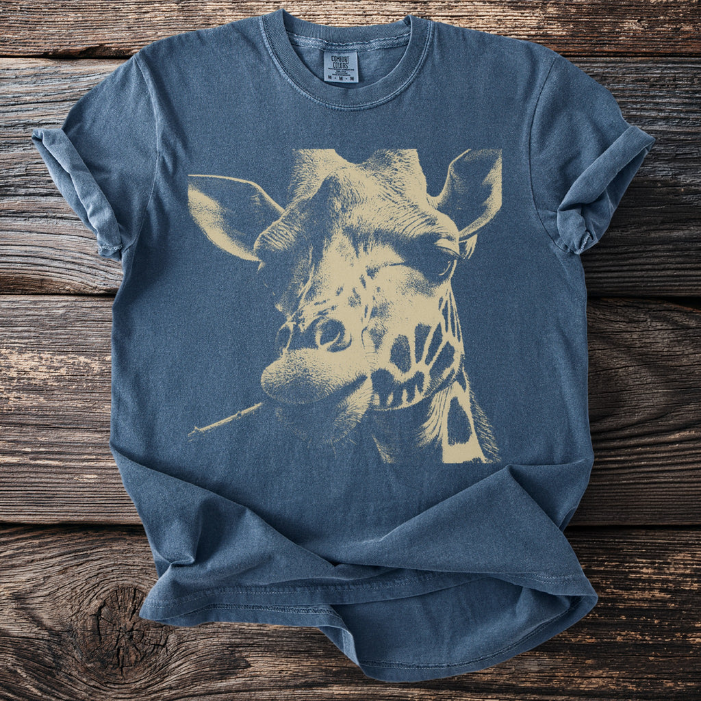 Blue t-shirt with a tan graphic of a giraffe's head eating a leaf.