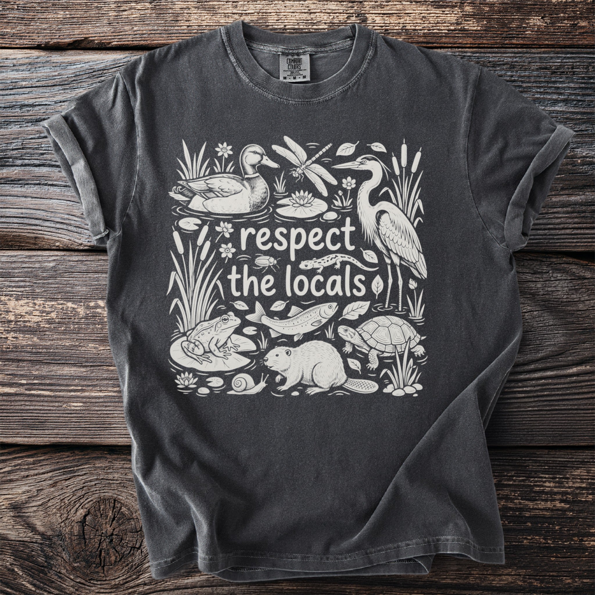 Dark grey t-shirt with "respect the locals" text and wildlife illustration.