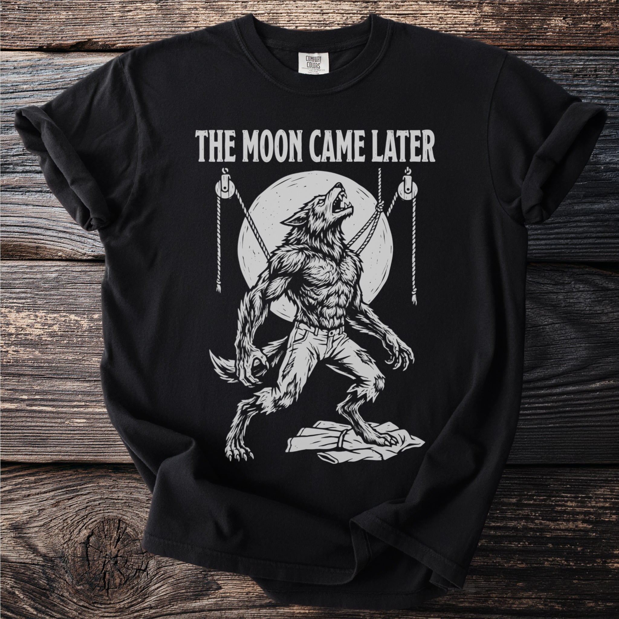 Werewolf howling at the moon graphic with "The Moon Came Later" text on a black t-shirt.