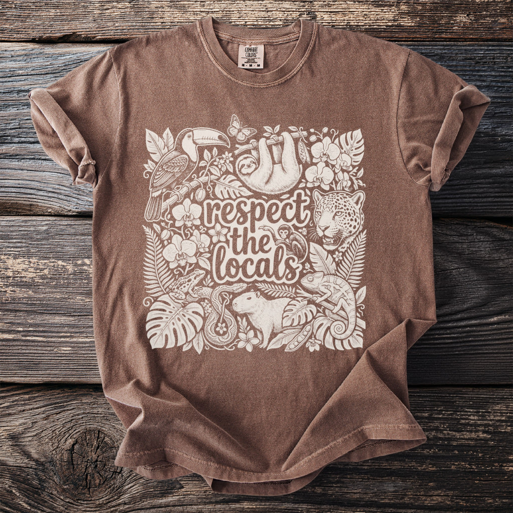 Brown t-shirt with white print of jungle animals and text "respect the locals".