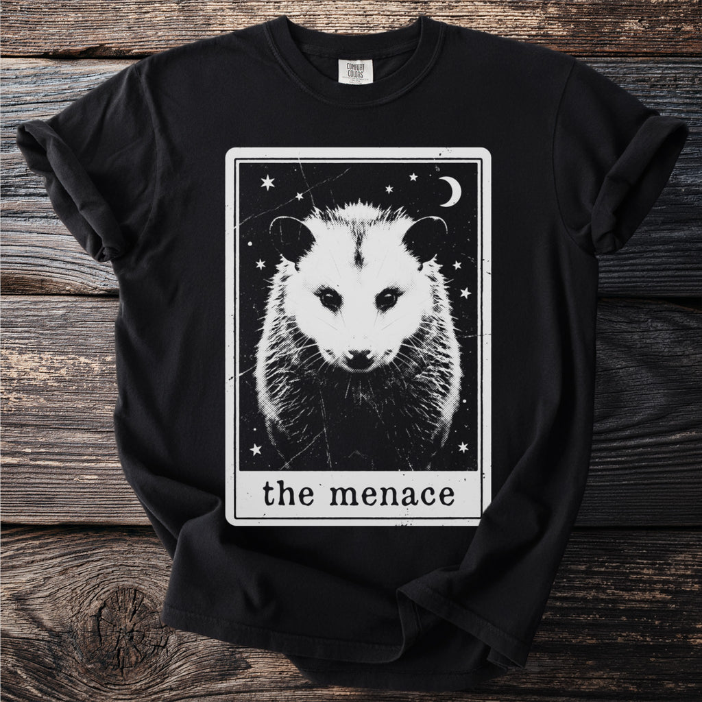 Black t-shirt with a tarot-style graphic of an opossum and the text "the menace."