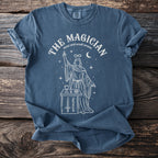 Blue t-shirt with white line art of The Magician tarot card and "tarot card occult arcana."