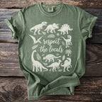 Green t-shirt with white line art of various dinosaurs and plants, and text "respect the locals".