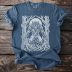 Blue t-shirt with white werewolf illustration in a forest under a full moon.