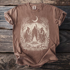 Brown Comfort Colors t-shirt with a cream graphic of figures around a bonfire under a moon.