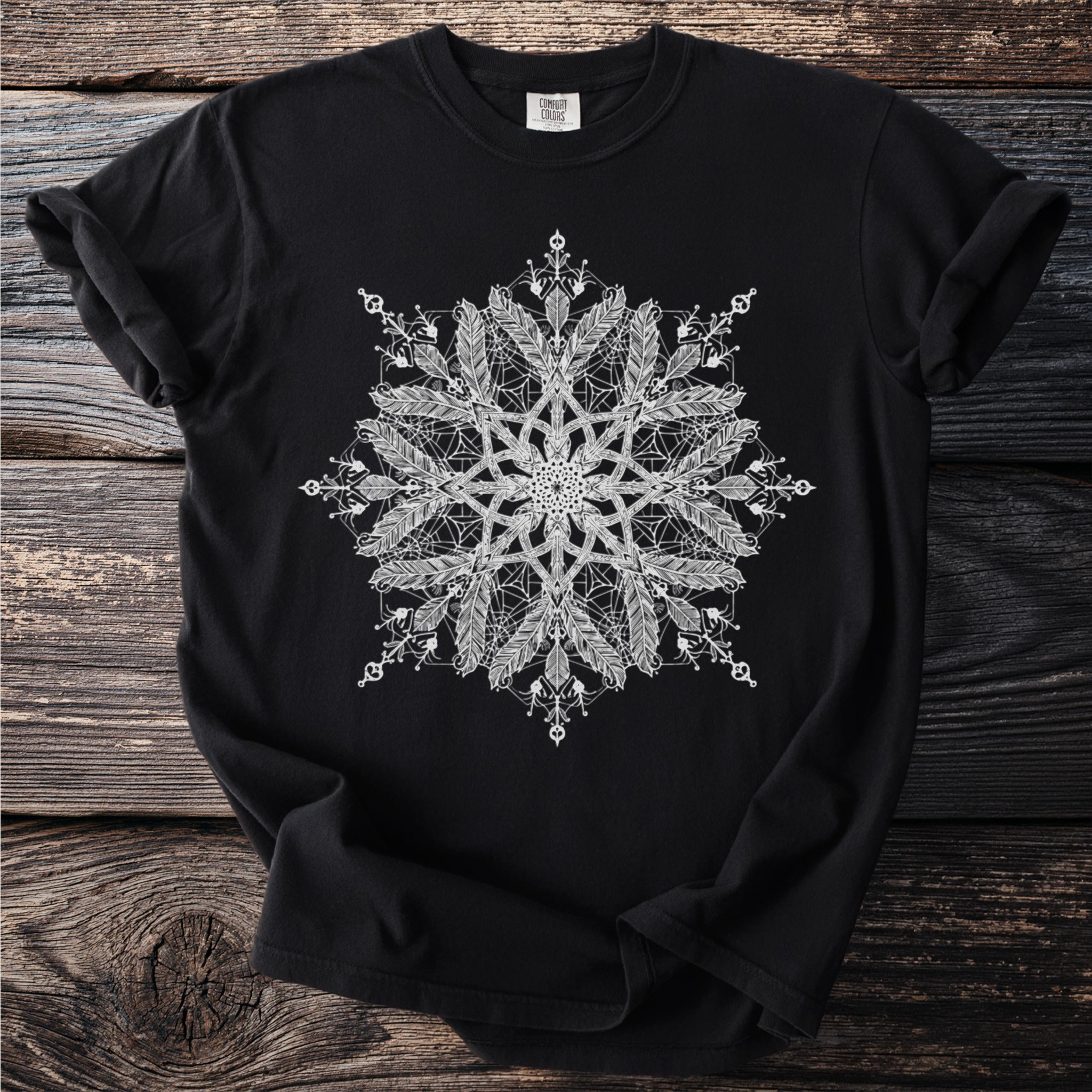 Comfort Colors black t-shirt with white feather and geometric mandala graphic.