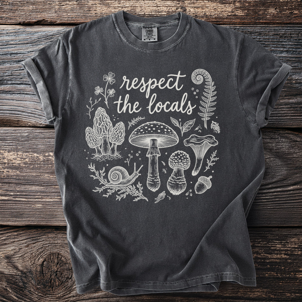 Dark gray t-shirt with white line art of mushrooms, a snail, fern, and text "respect the locals".