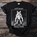 Black t-shirt with "soft heart sharp teeth" text and wolf graphic.