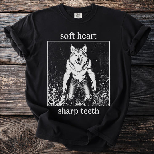 Black t-shirt with "soft heart sharp teeth" text and wolf graphic.