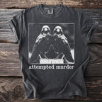 Dark charcoal t-shirt with a white graphic of two ravens and the text "attempted murder".
