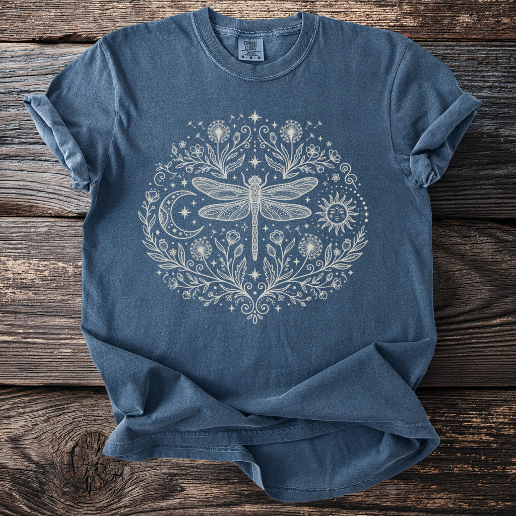Blue t-shirt with cream dragonfly, sun, moon, and floral design.