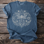 Blue t-shirt with cream dragonfly, sun, moon, and floral design.
