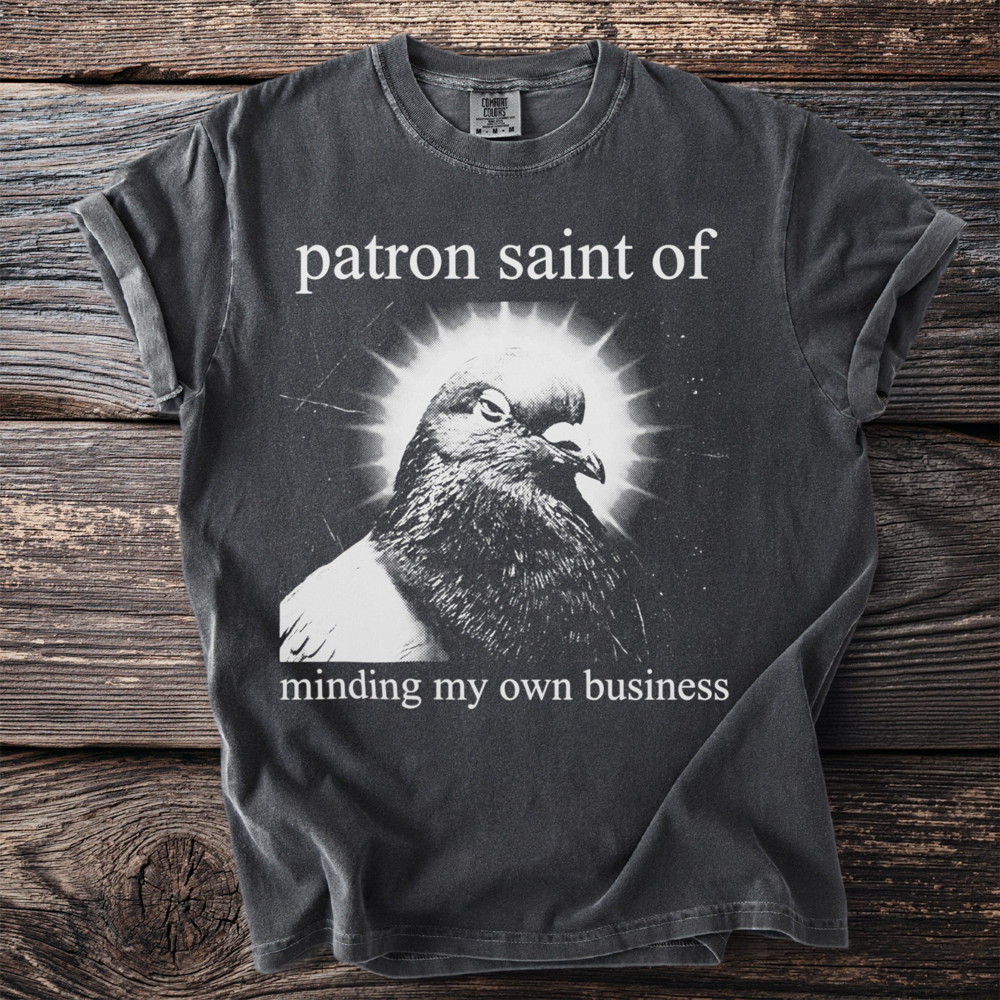 T-shirt with pigeon image and text "patron saint of minding my own business".
