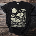 Black t-shirt with a light cream moon, moth, flowers, and starry night print.