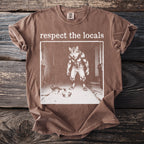 Brown t-shirt with graphic of a werewolf and a kitten, reading "respect the locals".