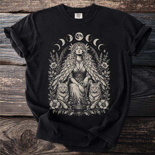 Black t-shirt with a centered illustration of a woman with cats, flowers, and moon phases.