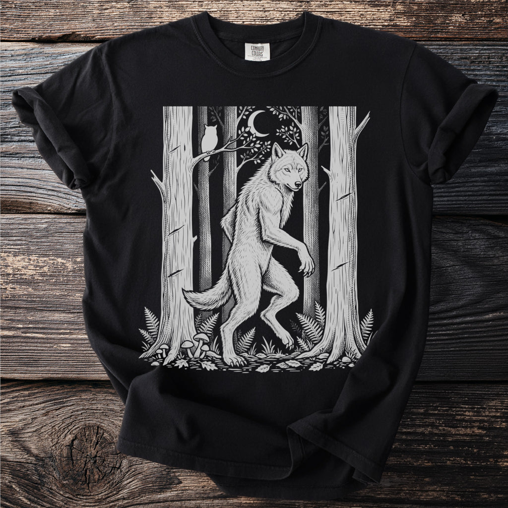 Werewolf in a forest scene with an owl and moon, printed on a black t-shirt.