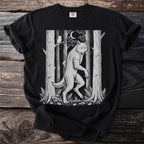 Werewolf in a forest scene with an owl and moon, printed on a black t-shirt.