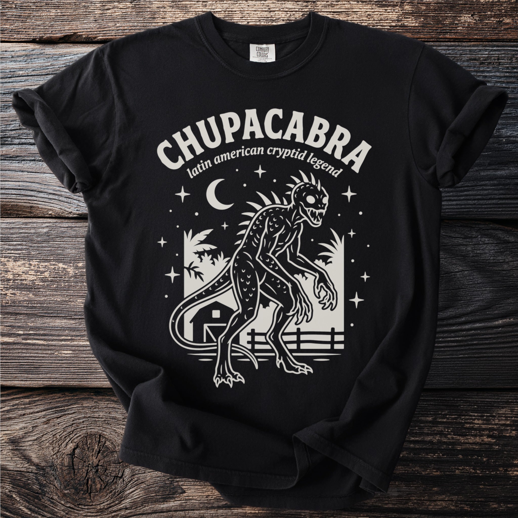 Black t-shirt with a Chupacabra graphic and text: "Chupacabra latin american cryptid legend".