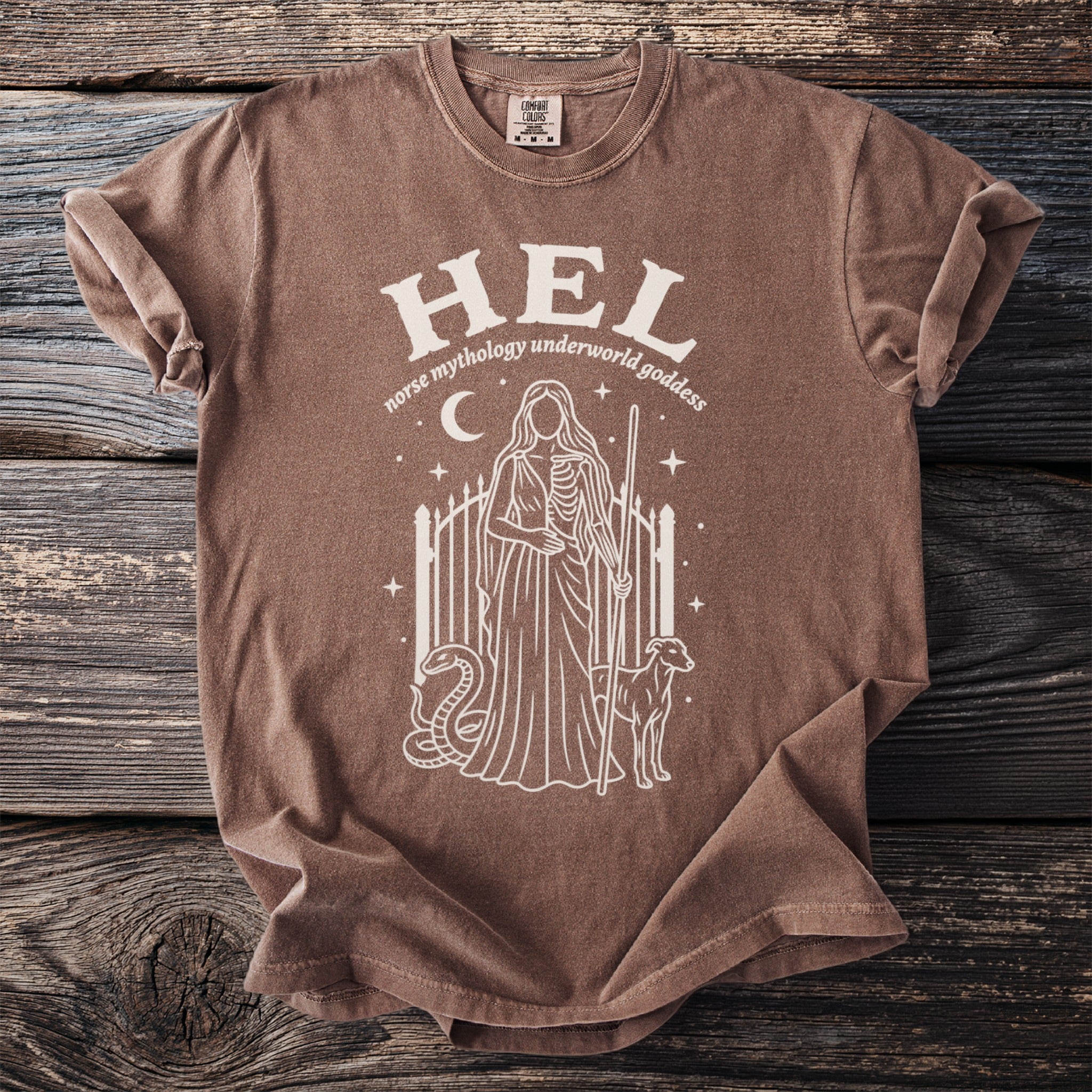 Brown t-shirt with white graphic of Hel, Norse underworld goddess, with dog, snake, and gate.