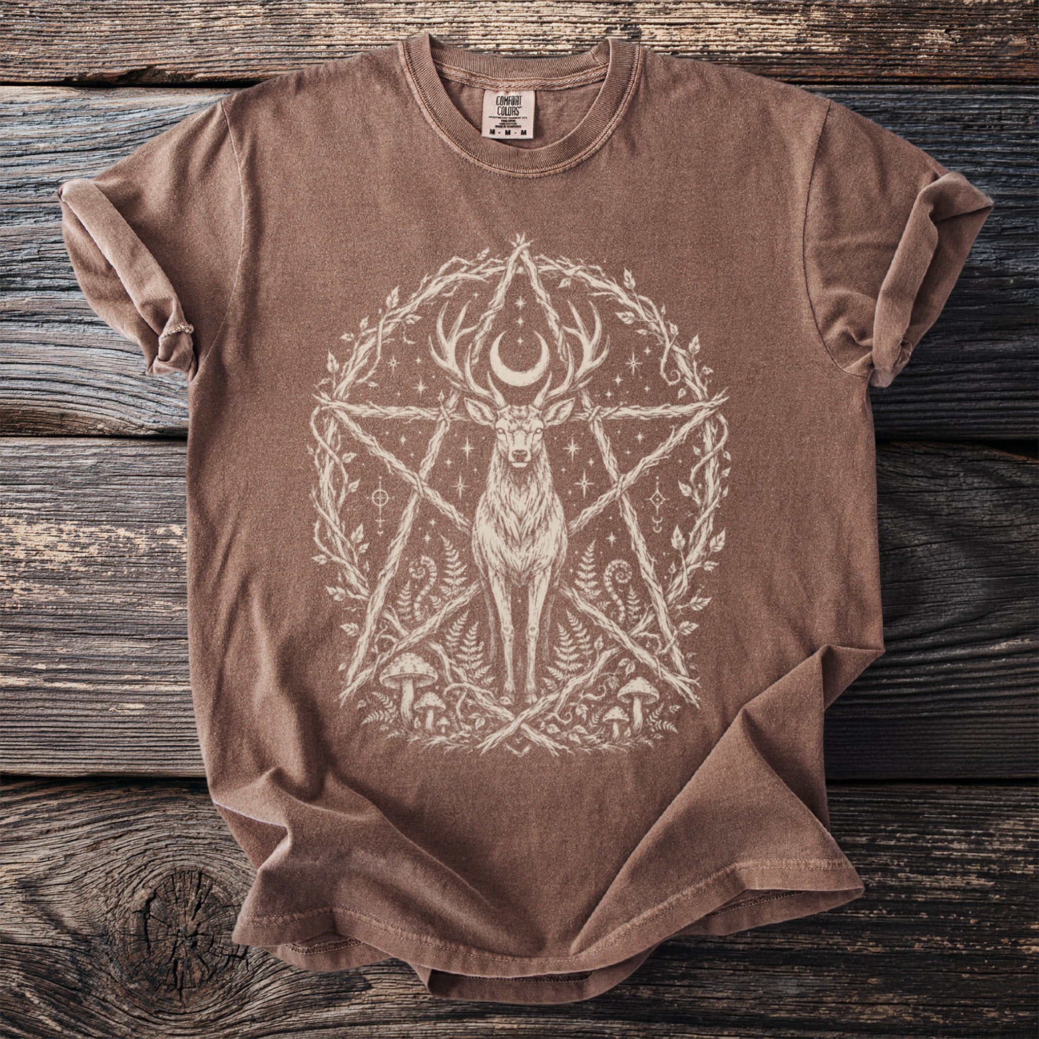Brown t-shirt with a large, cream-colored deer wearing a crescent moon in a linework pentagram design.