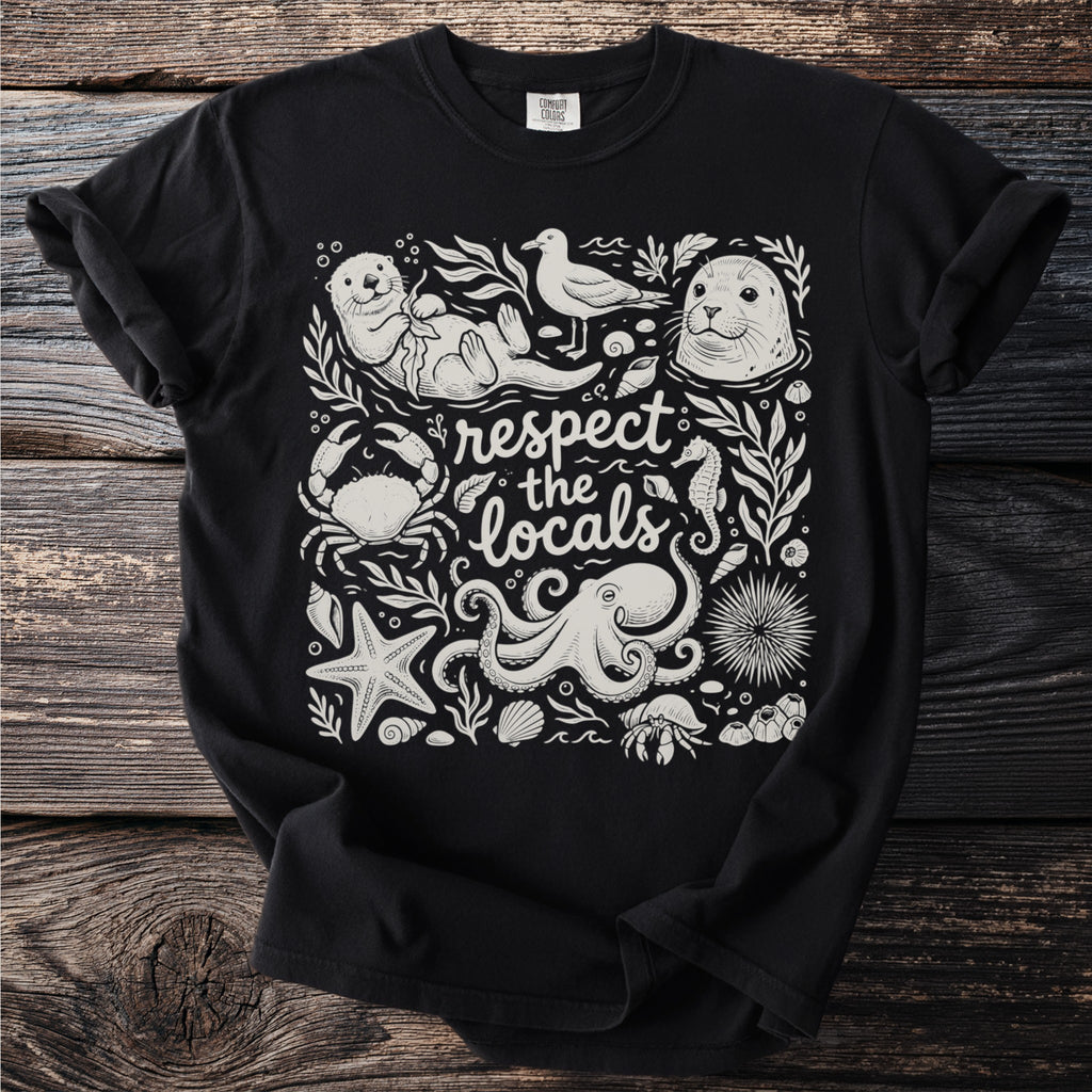 Black t-shirt with white illustration of sea creatures and text "respect the locals".