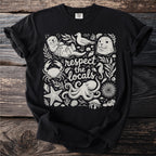 Black t-shirt with white illustration of sea creatures and text "respect the locals".