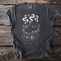 Black cat in a cauldron with bones, ornaments, and moon.