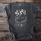 Black cat in a cauldron with bones, ornaments, and moon.