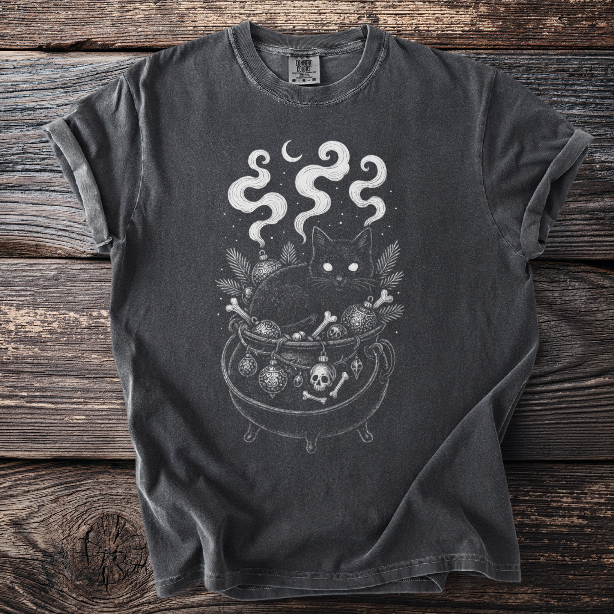 Black cat in a cauldron with bones, ornaments, and moon.