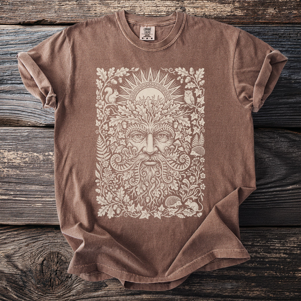 Brown t-shirt with a detailed cream linework design of a Green Man amidst foliage and woodland creatures.