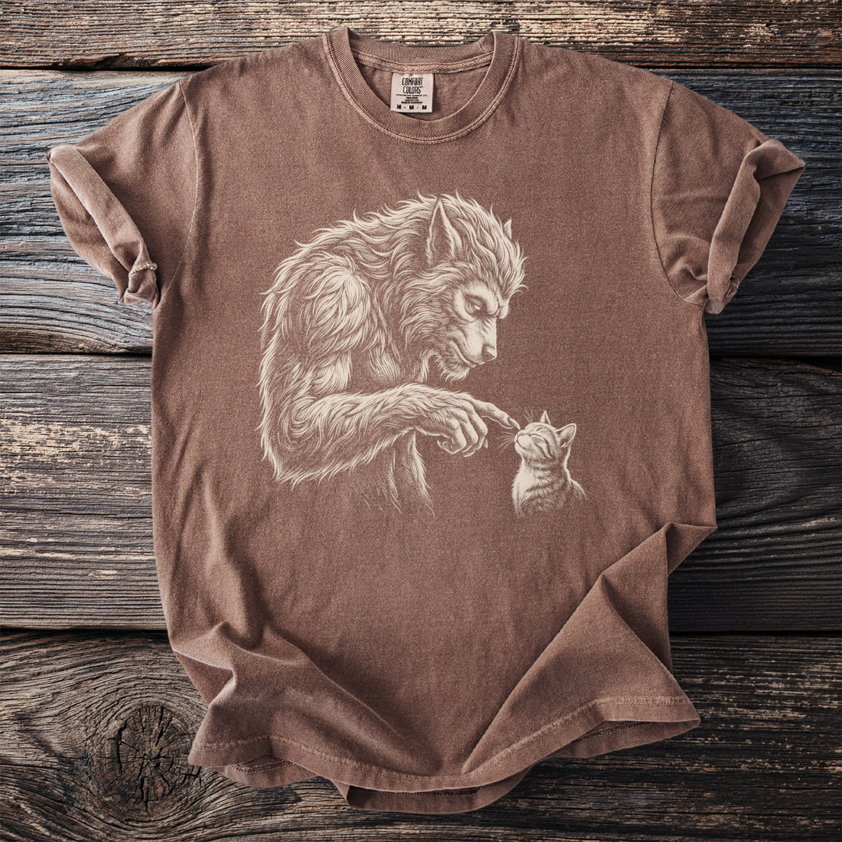 Brown t-shirt with a werewolf and cat illustration and Comfort Colors tag.
