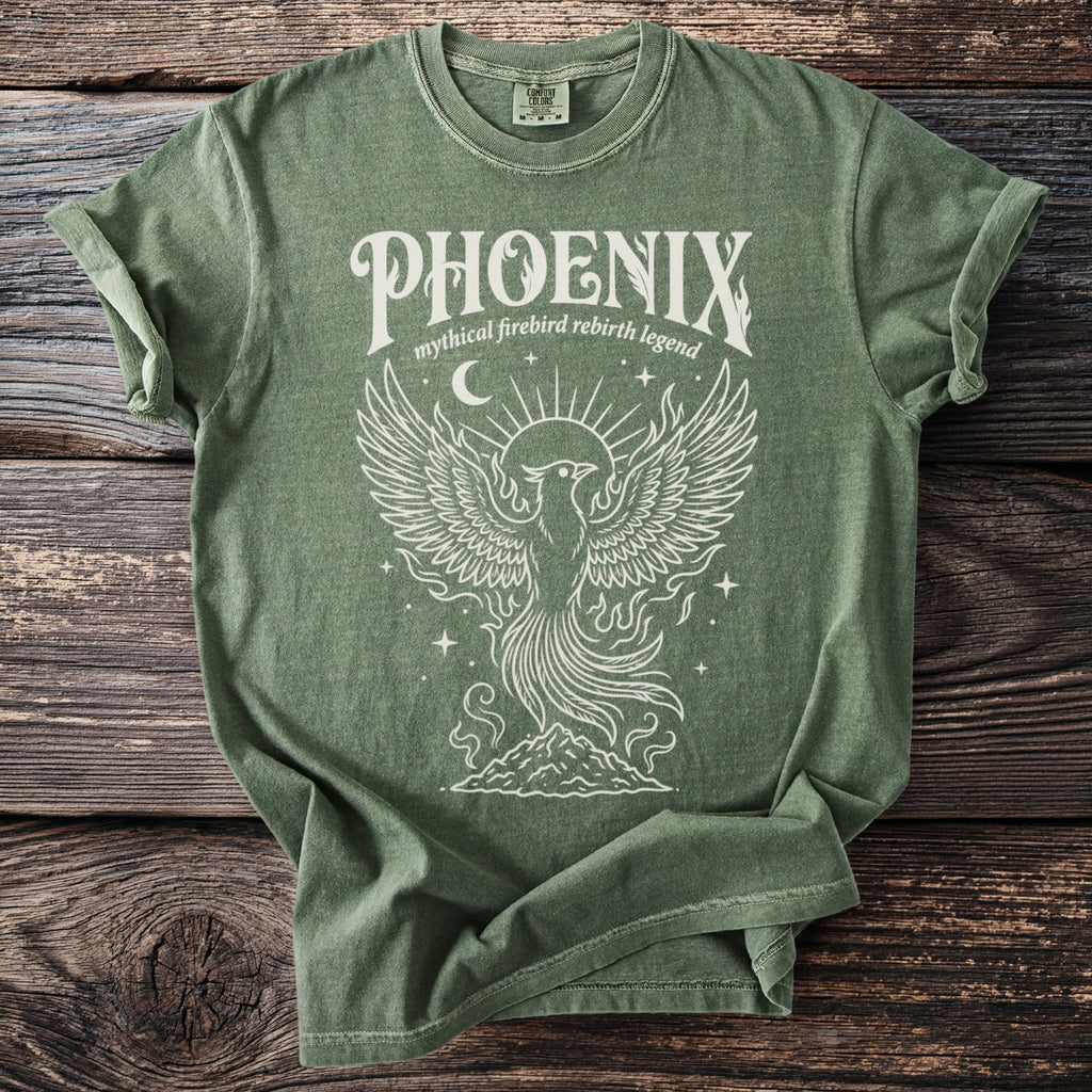 Green t-shirt with white line art of a phoenix rising from mountains.