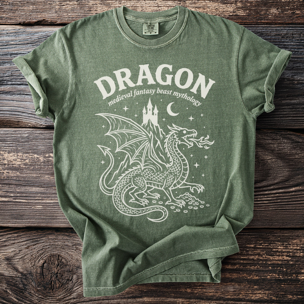 Green t-shirt with white dragon, castle, moon, and stars graphic.