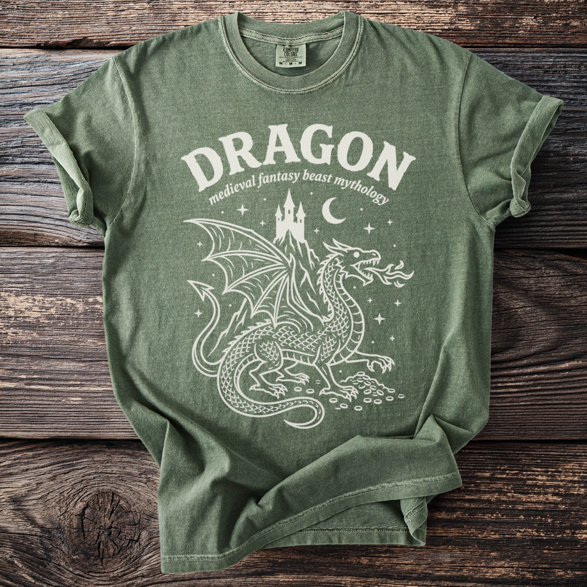 Green t-shirt with white dragon, castle, moon, and stars graphic.