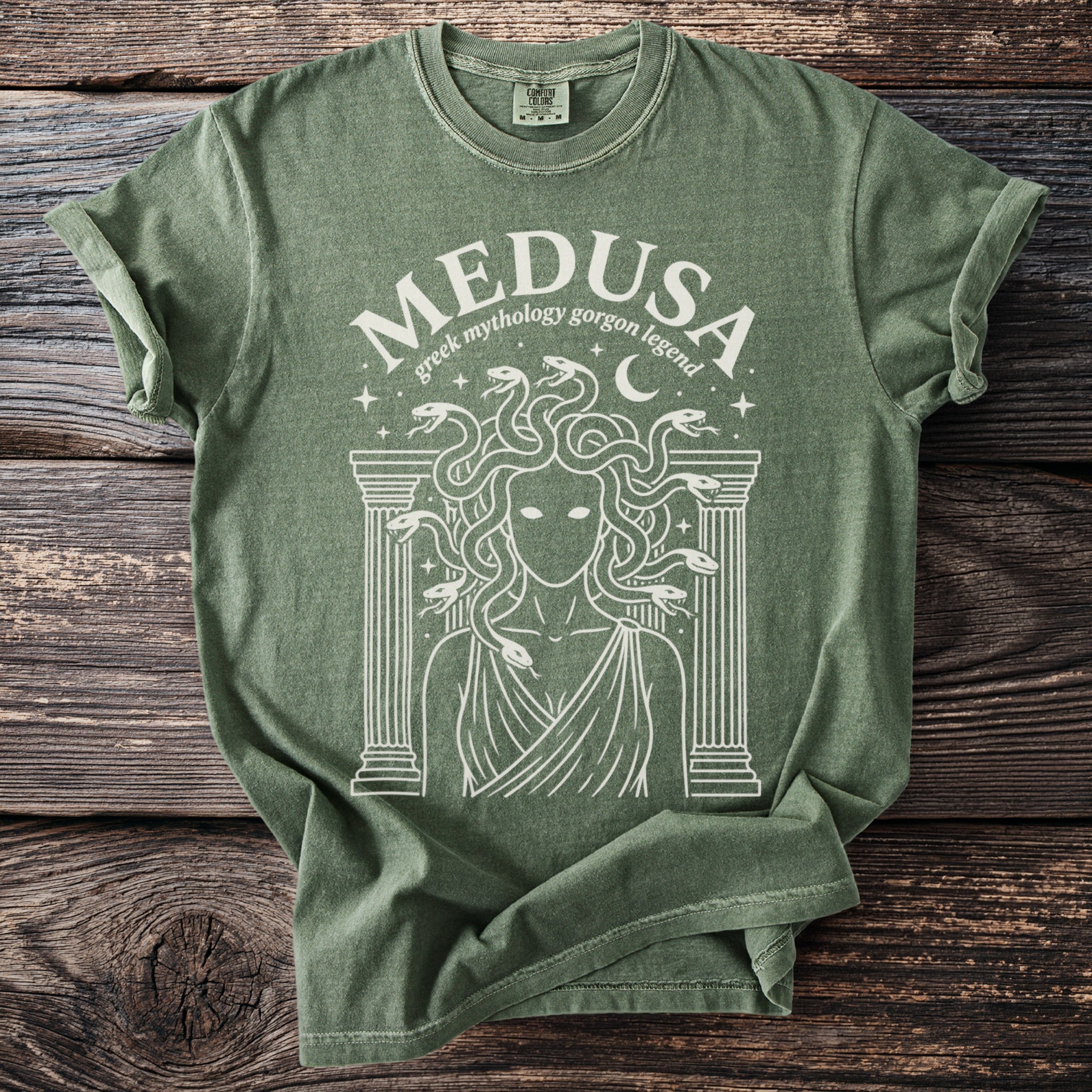 Green t-shirt with a white Medusa graphic and Greek mythology text.