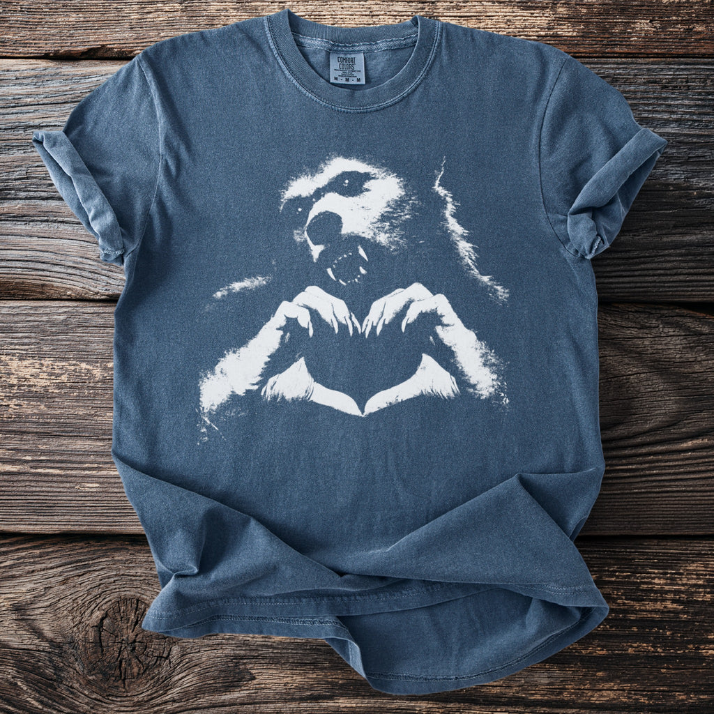 Blue t-shirt with white werewolf head making heart shape with paws.