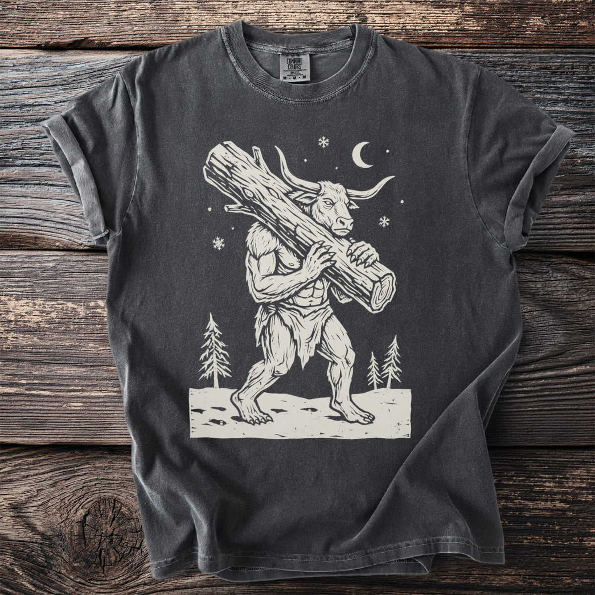 Pepper gray t-shirt with a cream folk-cut print: the Minotaur walks through the snow with a huge Yule log over his shoulder.