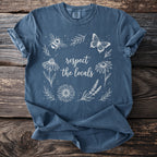 Blue t-shirt with white line art of bee, butterfly, flowers, and text: "respect the locals"