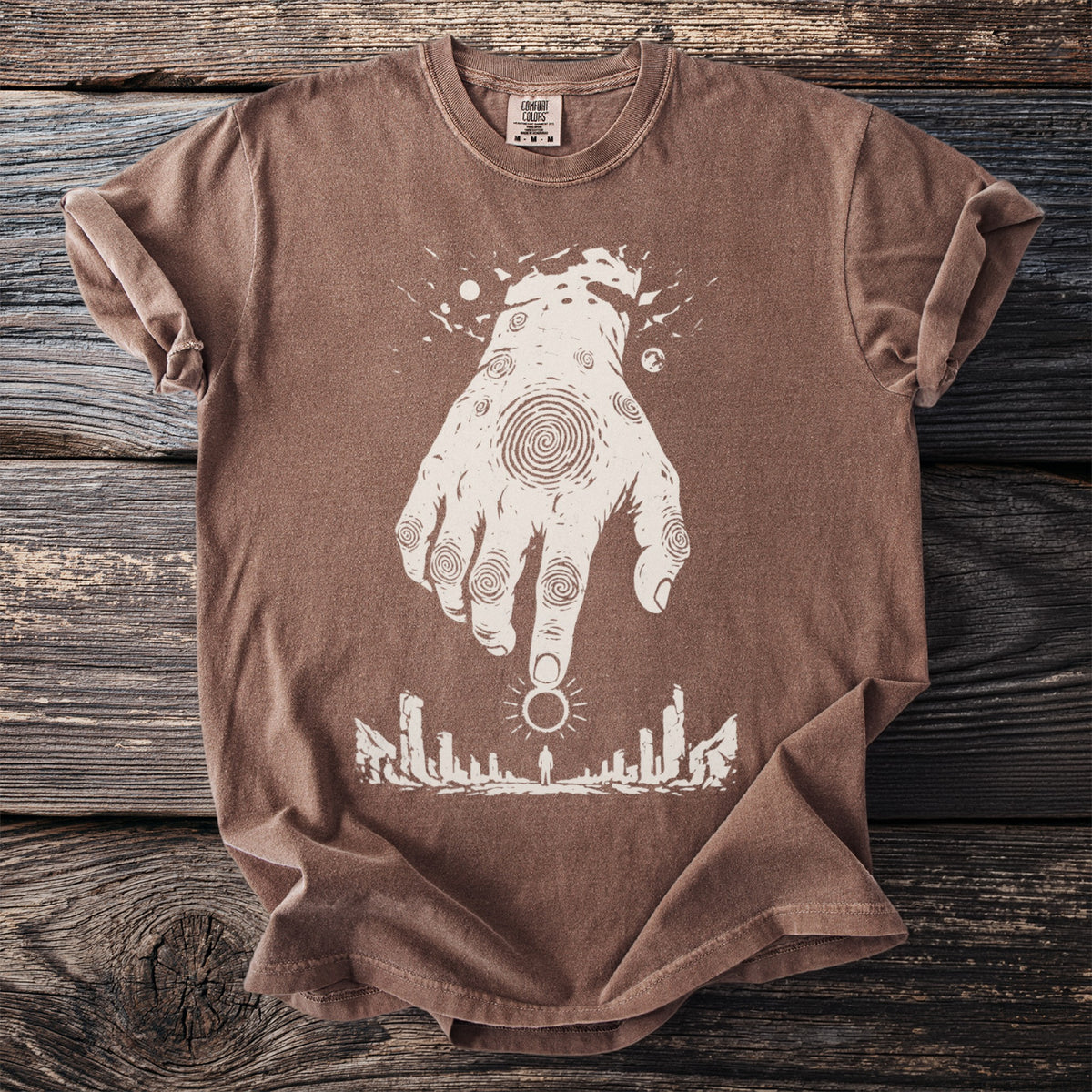 Brown t-shirt with white graphic of a hand reaching down to a figure under a sun.