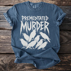 Blue t-shirt with white text "PREMEDITATED MURDER" and white ravens.