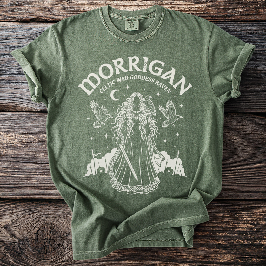 Green t-shirt with white graphic of Morrigan, Celtic war goddess raven.