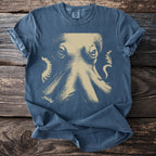 Blue Comfort Colors t-shirt with a faded tan octopus graphic and text.