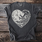 T-shirt with white linocut design of two cats in a heart shape, flowers, and crescent moon.