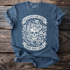 Blue t-shirt with a skull, snake, and plants design that reads "All plants are edible, some only once".